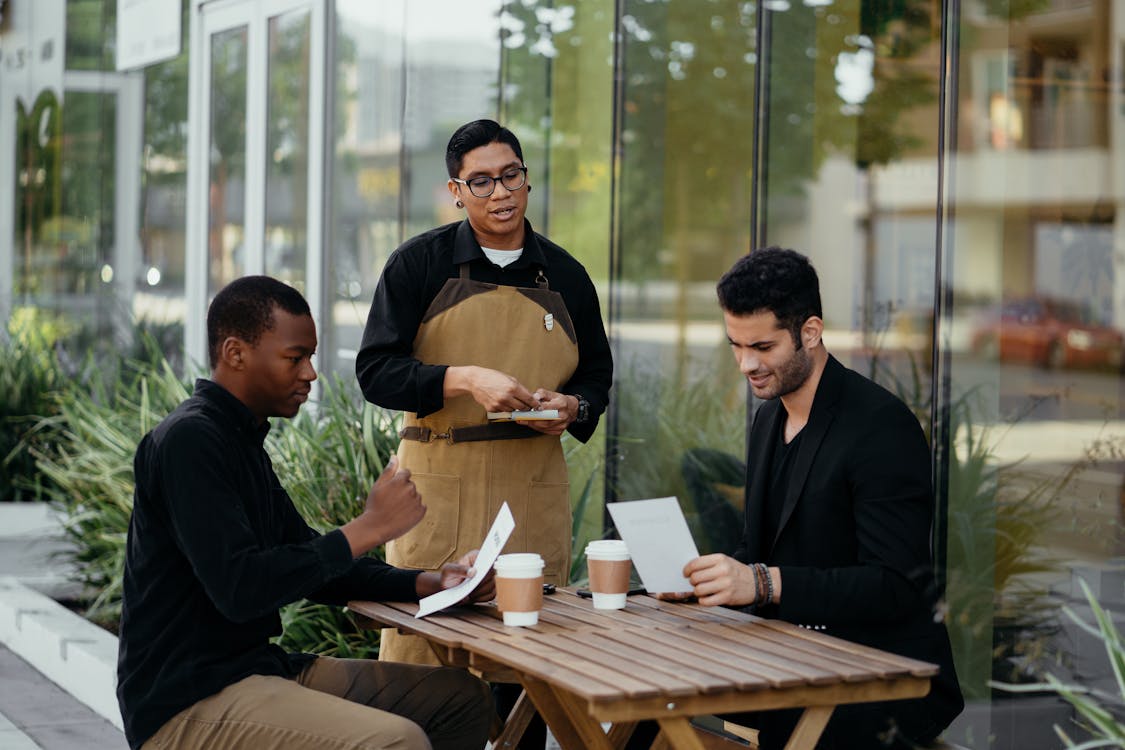 Free Waiter Taking Orders from Customers Stock Photo